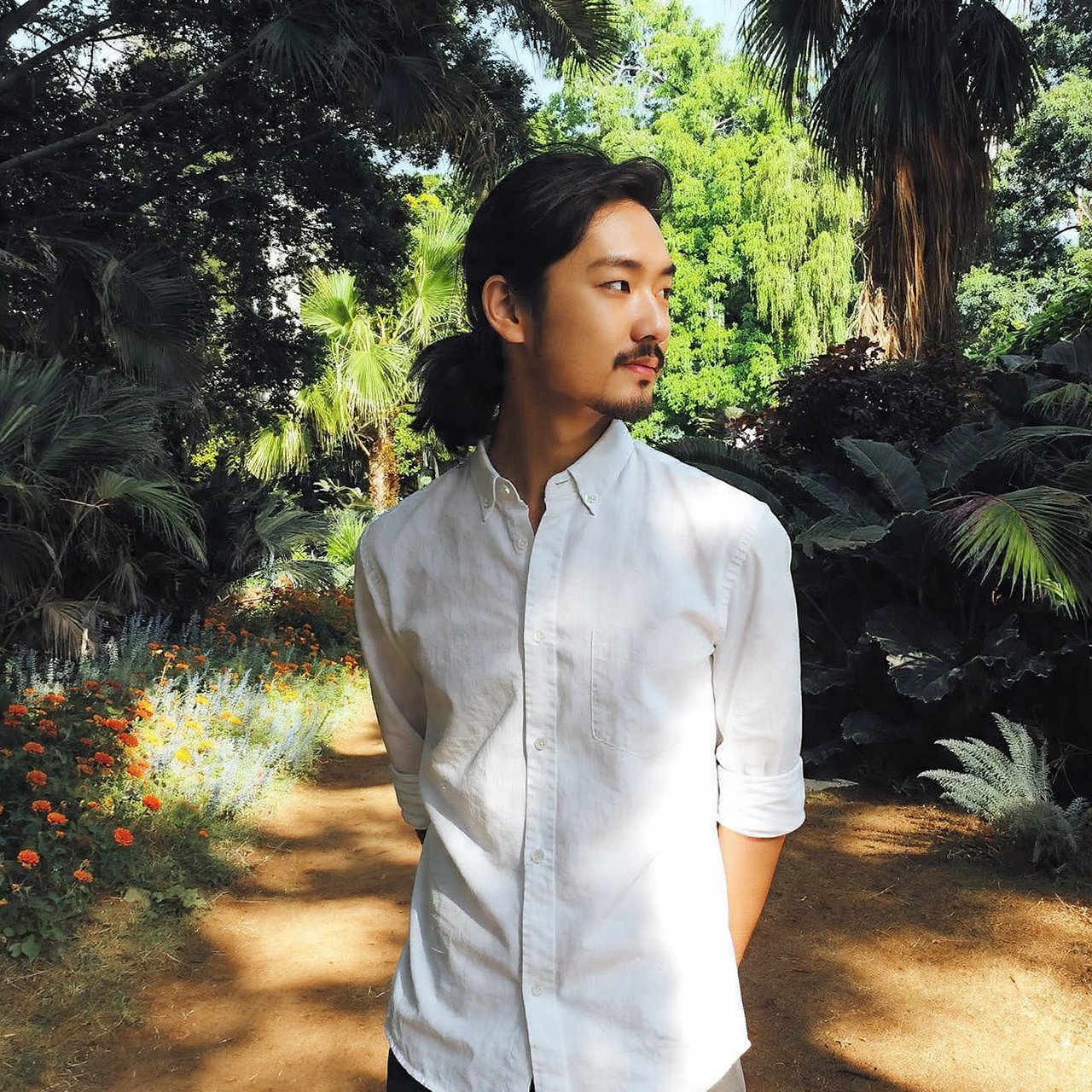 Master the Flow: 27 Long Haircuts for Men Ideas & Tips 14 a man with a half up half down hairstyle