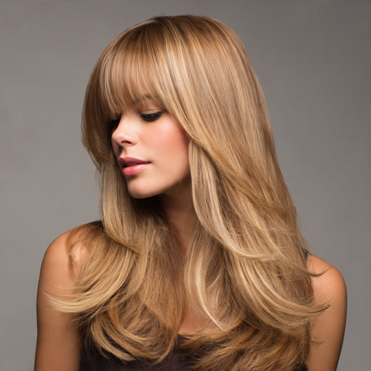 a stylish blonde hairstyle featuring soft bangs