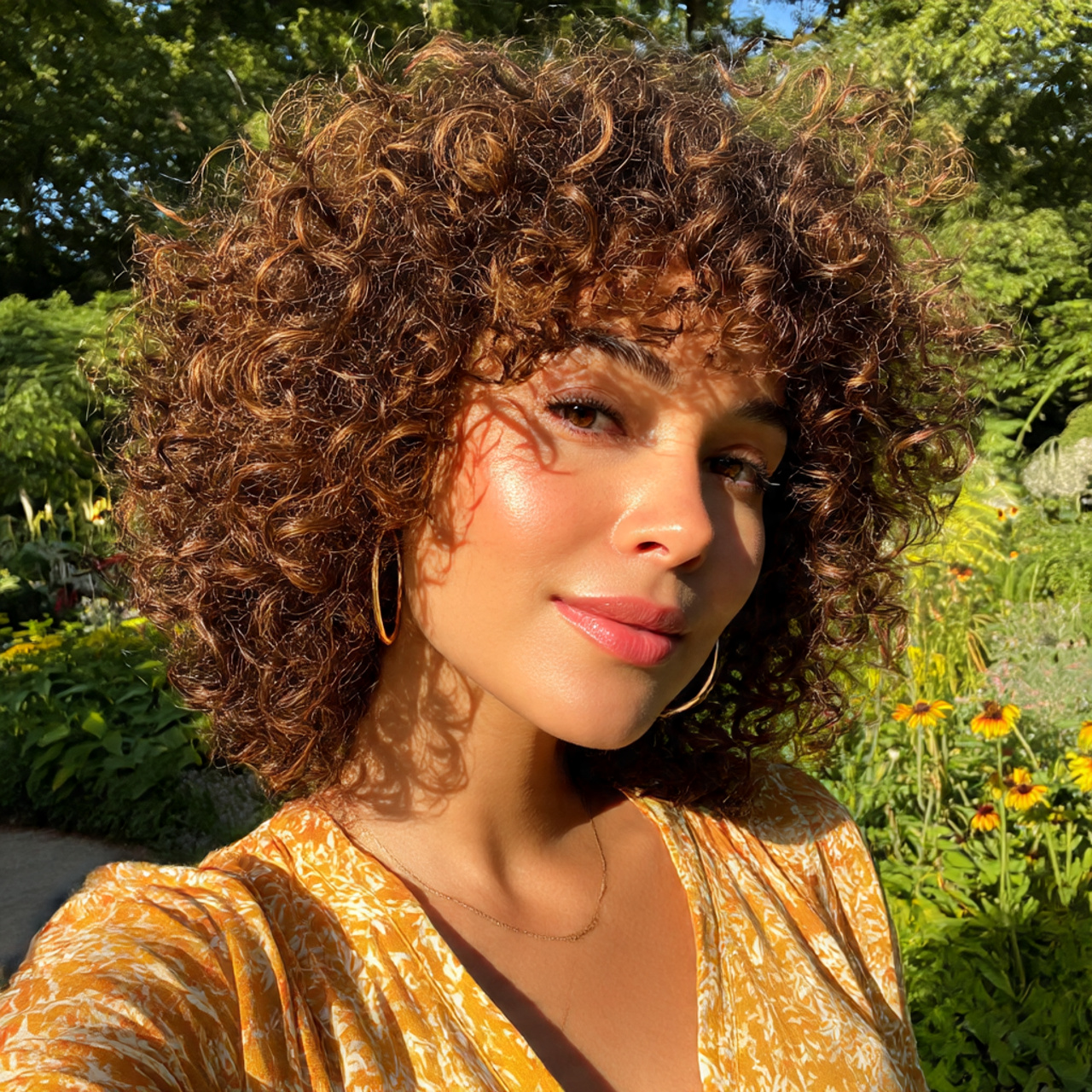 a woman with naturally curly hair wearing