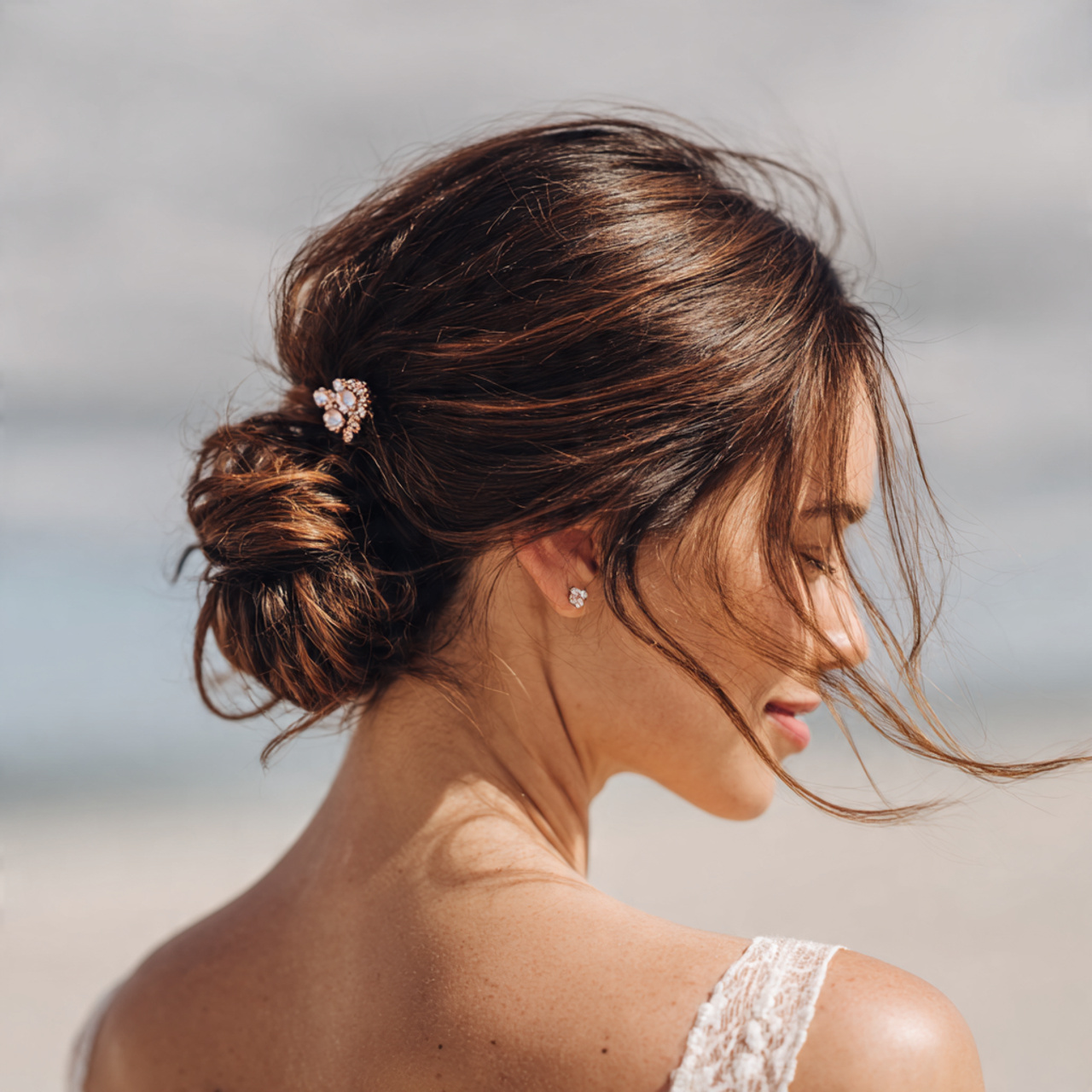 Beach Wedding Hair: 12 Wind-Proof & Beautiful Styles 6 an attractive woman having beachy sleek low bun wi