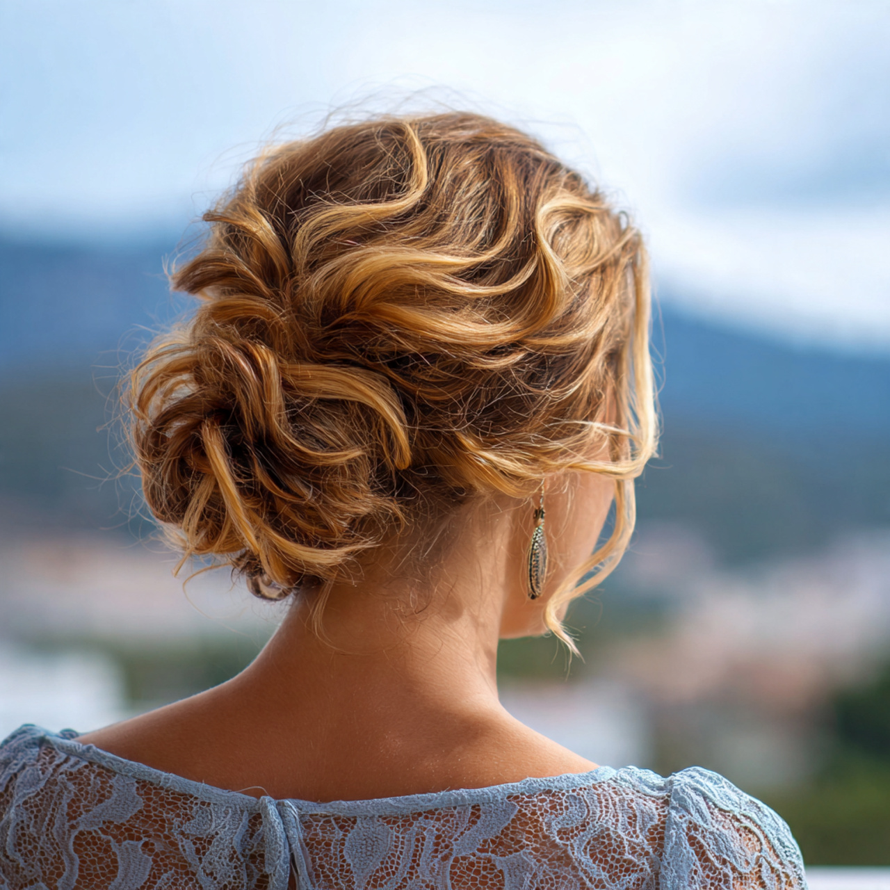 an attractive woman having easy loose curly low bu