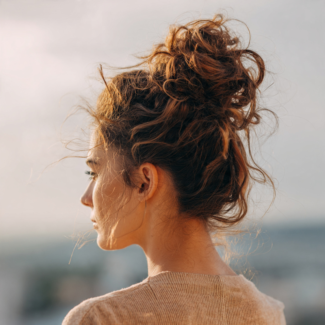 an attractive woman having easy messy high bun thi