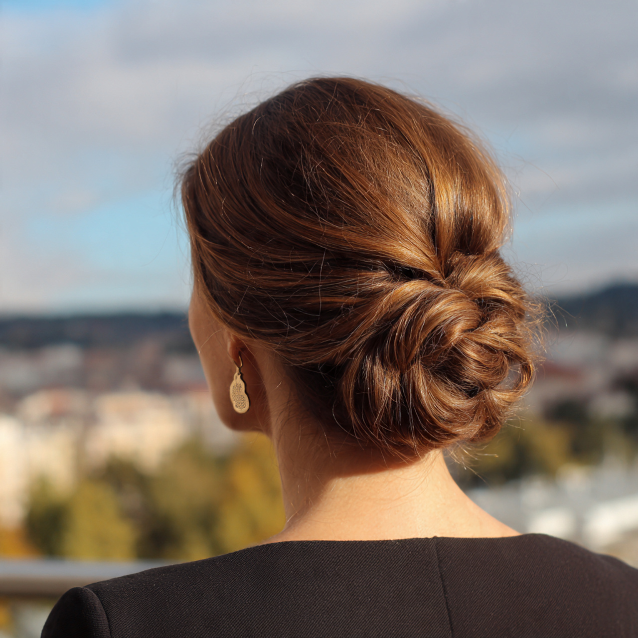 an attractive women having low twisted chignon eas